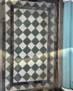 an old tiled wall with some blue and white tiles on the bottom, next to a radiator