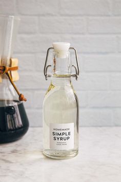 an empty glass bottle sitting on top of a counter