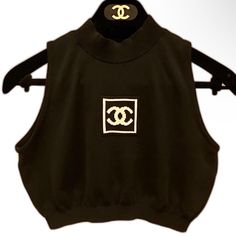 Chanel Identification Cc Black Crop Top Sz36 The Most Iconic Crop Top From Chanel. This Is For A Serious Collector Of Chanel. This Was Not On Market For Years, No Matter The Amount Of Money Paid. Identical One Seen On Ariana Grande. Not In A Rush To Sell The Chanel Identification Line Is A Chanel Specialty Line Made In The Late 90's Thru Early 2000's. This Is A Little Black Top Made In France Of 100% Cotton. The Logo On The Front Is Cream And Black. Dry Clean Only. Wore Only Once; Like New Condi Chanel Tank Top, Chanel Sleeveless Top, Chanel Crop Top, Luxury Embellished Black Crop Top, Chanel 90s, Farfetch Black Crop Top, Black Crop Top, Stretch Bands, Black Crop