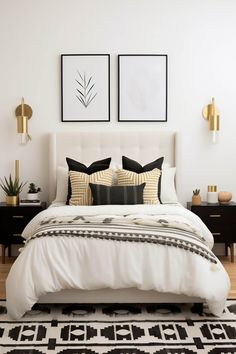 a white bed with black and gold pillows