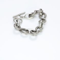 Vintage Gucci sterling silver rope link bracelet with toggle clasp. Approximate Measurements: Chain Length 7.8", Width 0.7" Weight: 71.3 Grams Made in: Italy Luxury Chain Link Bracelet With Sterling Silver Clasp, Luxury Oval Link Bracelet With Toggle Clasp, Luxury Link Chain Bracelet With Toggle Clasp, Formal Bracelets With Hook And Links, Classic Chain Link Jewelry With Toggle Clasp, Classic Sterling Silver Cable Chain Bracelet, Designer Silver Jewelry With Solid Link Construction, Classic Sterling Silver Bracelet With Toggle Clasp, Elegant Sterling Silver Bracelet With Oval Link Toggle Clasp