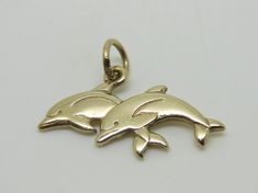 This beautiful charm is an authentic James Avery piece in yellow gold stamped with the candle sticks 14K ©. The charm is called Twin Dolphins and it is a retired piece and a very rare find. The charm measures 1" in length and the jump ring is cut. The charm does not come in its original packaging. RING SIZE: N/A TOTAL WEIGHT: 2.3 Grams CONDITION: Excellent REF. CODE: LB3416 Feel free to Visit My ebay Store and browse through my other items for some more unique fine jewelry and collectibles. All Vintage Gold Charms Stamped 14k, Symbolic Yellow Gold Charms For Gift, Symbolic Engraved Yellow Gold Charms, Classic Gold Charms For Anniversary, Vintage 14k Gold Charms For Gift, Engraved Yellow Gold Charms For Collectors, 14k White Gold Charms For Anniversary, Heirloom 14k Gold Charms For Gifts, Heirloom Yellow Gold Charms For Gift