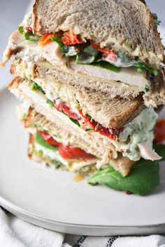 a cut in half sandwich sitting on top of a white plate