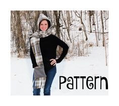 a woman standing in the snow with her hands on her hips wearing a plaid scarf