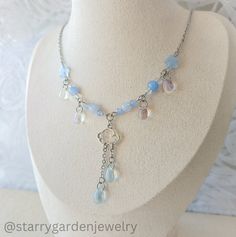 * Blue Raindrops Charm Necklace *  Made with clear and blue glass drops, soft blue glass beads and a cloud charm. * Materials: Stainless steel, glass beads and alloy charms. * Length: 44.5-47.5 cm. ➤ 𝘑𝘦𝘸𝘦𝘭𝘳𝘺 𝘊𝘢𝘳𝘦 ❀ Please handle this delicate product with care. ❀ Please avoid exposing it to water, perfumes, lotions, and harsh chemicals. ❀ Store your jewelry in a dry, clean place to prevent tarnishing and scratches. ➤ 𝘚𝘩𝘪𝘱𝘱𝘪𝘯𝘨 𝘐𝘯𝘧𝘰𝘳𝘮𝘢𝘵𝘪𝘰𝘯 ❀ Please note that sometimes Water Necklace, Necklace Fairycore, Cottagecore Necklace, Fairycore Necklace, Glass Bead Jewelry, Diy Collier, Glass Beads Jewelry, Celestial Necklace, Beaded Necklace Diy