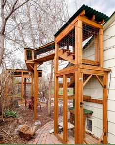 an outdoor chicken coop made out of wood and wire