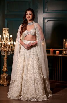 This delicate ivory lehenga features all over sequin, cutdana, crystal and pearl embroidery paired with a strappy embroidered blouse. The embroidered dupatta is crafted in net.DELIVERY TIMEPlease allow 8-12 weeks for your outfit to arrive.FABRIC DETAILSNetProfessional cleaning only. Off White Sharara With Sheer Dupatta For Reception, Off-white Sharara With Sheer Dupatta For Reception, Elegant Off-white Choli With Dupatta, Festive Off White Choli With Sheer Dupatta, Off White Embroidered Choli For Reception, Elegant Cream Choli With Sheer Dupatta, Embellished Cream Lehenga For Wedding, Elegant White Kundan Choli, Glamorous Dupatta With Pearl Embroidery For Festive Occasions