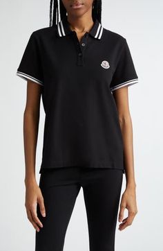 Cut in a slim fit from cotton piqué, this polo checks all the boxes of classic styling with its tipped collar and cuffs and the distinctive Moncler logo patch. Button half-placket Spread collar Short sleeves Side slits Drop-tail hem 100% cotton Dry clean or machine wash, dry flat Made in Turkey Designer Clothing Designer Black Polo Shirt With Ribbed Collar, Designer Black Cotton Polo Shirt, Designer Black Polo Shirt With Embroidered Logo, Classic Black Polo Shirt With Contrast Collar, Casual Polo Shirt With Embroidered Logo For Work, Black Polo Shirt With Ribbed Collar, Casual Workwear Polo Shirt With Embroidered Logo, Fitted Black Polo Shirt With Striped Collar, Designer Black Polo Shirt For Work