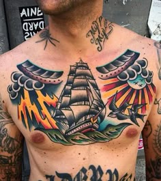 a man with tattoos on his chest has an eagle and ship tattoo on his chest