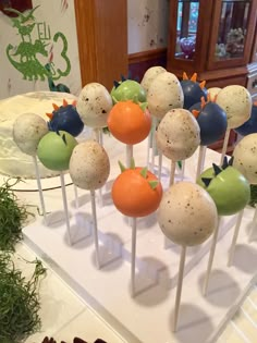 there are many cake pops with different toppings on the sticks in front of them