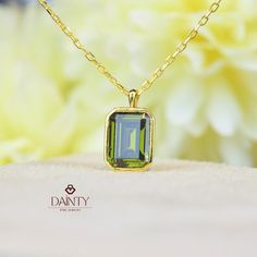 Peridot Necklace I 14K Solid Gold Peridot Pendant I Rectangle Bezel Necklace I May Birthstone Jewelry I Anniversary Gift I Christmas Gift Item Gemstone: AAA Grade Peridot Cubic Zirconia Size: 7*5 mm  Color: Green Shape: Emerald Cut  Average Quality: AAA+ This exquisite necklace features a captivating peridot stone, known for its vibrant green hue that exudes a sense of freshness and vitality. The peridot stone measures 7x5 millimeters, making it a perfect size to catch the eye without being overly ostentatious.  Cut into an elegant emerald shape, the stone is designed to enhance its natural brilliance and clarity. The emerald cut, known for its step-like facets, highlights the peridot's depth and rich color, creating a mesmerizing play of light and shadow. Encased in a sleek bezel setting, Fine Jewelry Green Rectangular Jewelry, Rectangular Green Gemstone Jewelry, Green Rectangular Fine Jewelry, Gold Peridot Jewelry With Emerald Cut, Green Gemstone Necklace With Rectangular Stone, Elegant Rectangular Peridot Jewelry, Green Rectangular Pendant Jewelry For Anniversary, May Birthstone Rectangular Gemstone Necklaces, Rectangular May Birthstone Gemstone Necklace