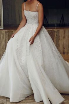 a woman in a white wedding dress posing for the camera