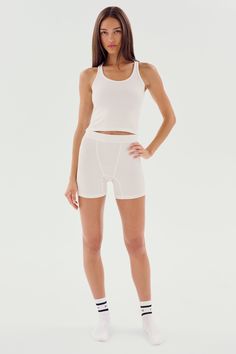 A cropped version of our fabulous Ashby tank. Super soft baby rib fabric hugs your body and layers effortlessly. BEST FOR: running, yoga, CrossFit, barre, Pilates, spin class, cycling and gym workouts. Sporty Crop Top With Built-in Shorts For Gym, Summer Cropped Activewear For Pilates, Cropped Summer Activewear For Pilates, Cropped Activewear For Pilates In Summer, White High Stretch Seamless Crop Top, White Seamless High Stretch Crop Top, White Cropped Seamless Sports Bra, White Stretch Racerback Crop Top, White Cropped Tank Top With Medium Support