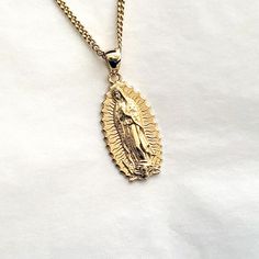 women's and men's our lady of guadalupe necklace pendant 6 made in real 14k solid gold or real 18k solid gold our lady of guadalupe is a catholic title of the blessed virgin mary associated with a series of five marian apparition in Dec 1531. it is based on a venerated image on a cloak enshrined within the basilica of our lady of guadalupe in mexico city. - this pendant height is 27mm without the bail. - model wears a 2.1mm 60cm chain. - materials: real 14k solid gold, real 18k solid gold - free shipping on all orders via Fedex! - made in south korea 14k gold blessed virgin mary pendant necklace 6 weight pendant only 7.71g (±3%) with a 2.1mm 42cm 13.67g (±3%) with a 2.4mm 42cm 15.54g (±3%) witah a 3.0mm 42cm 19.29g (±3%) 18k gold blessed virgin mary pendant necklace 6 weight pendant only 9 Lady Of Guadalupe Necklace, Guadalupe Necklace, Marian Apparition, Virgin Mary Pendant, Mary Necklace, Catholic Necklace, Virgin Mary Necklace, Mens Necklace Pendant, Crucifix Necklace