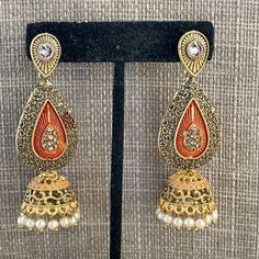 Women Earrings Gold Tone Fashion Jewelry Jhumka Style Faux Pearl Earrings U Branded Fashion Jewelry Color: Gold Length: 3 Inches Width: 1 Inch Brand New. Never Used. Traditional Orange Earrings For Party, Gold Bollywood Earrings For Festival, Gold Bollywood Festival Earrings, Bollywood Style Gold Earrings For Festival, Elegant Jhumkas For Festive Occasions, Orange Drop Earrings For Festive Occasion, Festive Orange Drop Earrings, Festive Jhumkas For Party, Women Earrings Gold