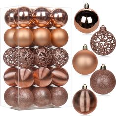 christmas ornaments are displayed in an acrylic display case, including gold and copper baubles