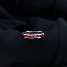 Product Details Fall in love with the beauty of this Created Ruby Eternity Ring. The ring features round cut created ruby in a stunning channel setting, creating a captivating effect. The ring is crafted in solid gold, providing durability and luxury. The full eternity band design makes it an elegant piece of jewelry that she will love to wear every day. Product Information SKU SHP-RINGS0821225550 Width 1.8 mm Height 3.5 mm Weight 2.48 gm (Approximate) LAB CREATED RUBY INFORMATION No.of Stones 2 Ruby Eternity Ring, Channel Setting, Full Eternity Ring, Band Design, Signature Jewelry, Ring Sizer, Timeless Jewelry, Ruby Gemstone, Eternity Band