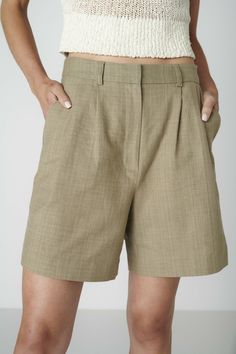 Want to look elegant and show a bit of leg? Discover the Bièl shorts in Sage Green. These shorts feature a high and slim fit at the waist, with a relaxed fit in the leg. They include a double pleat and two side pockets. The Bièl shorts are perfect for the warmer summer days, but also look stunning in the winter when paired with tights and boots. Complete your look with the matching June Jacket.The fabric is a mix of organic and recycled cotton. The yarns are traditionally plant dyed with red onions in India and then handwoven into a beautiful fabric, giving it a natural look and ensuring its uniqueness. The production is carried out by a family-owned business in Portugal.Size & FitFits true to size. Our model is 177cm (5 feet 9.7 inches) and wears size S. Material & CareThe fabric of the B Elegant Pleated Short Bottoms, Elegant Pleated High-waisted Shorts, Classic Bermuda Shorts With Built-in Shorts, Pleated High-waisted Shorts For Work, Chic Knee-length Bottoms With Pleated Waist, Classic High Waist Shorts With Pockets, Workwear Bottoms With Pleated Waist And Short Length, Elegant High-waist Pleated Shorts, Chic Pleated Shorts For Workwear