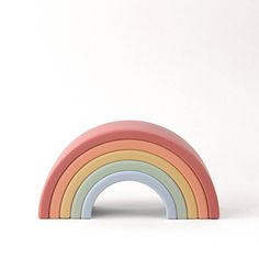 a rainbow shaped toy sitting on top of a white table