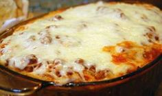 a casserole dish with cheese and meat in it sitting on a kitchen counter