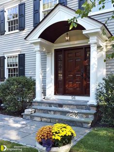 the front entrance to a house with flowers in a planter