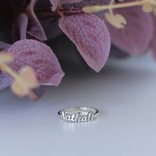 a close up of a ring on top of purple flowers