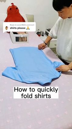 a man is making a t - shirt for someone to sew on the table