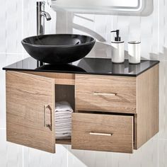 a bathroom vanity with a black bowl sink