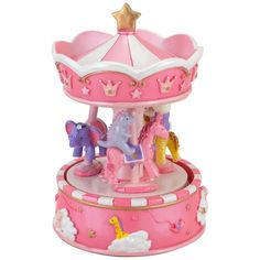 a pink toy carousel with horses on it