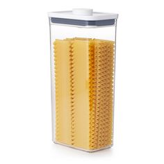 a plastic container with pasta in it on a white background and the lid is open