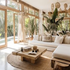 a living room filled with lots of furniture and plants on top of it's walls