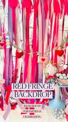 the cover of red fringe backdrop with pink and purple ribbons hanging from it's ceiling