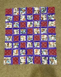 a red and blue quilt with pictures on it