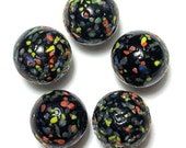 four black and multicolored confetti covered beads