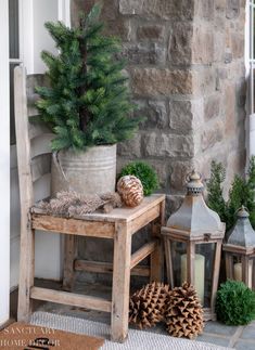 a wooden bench sitting next to a stone wall with potted plants on top of it