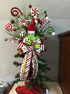 a christmas tree decorated with candy canes and candies on top of a table