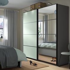 a bedroom scene with focus on the mirrored closet doors and shoes in the foreground