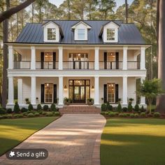 a large white house with black shutters on the front and side windows, surrounded by trees