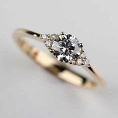 a yellow gold engagement ring with three diamonds