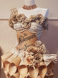 a dress made out of books and paper flowers