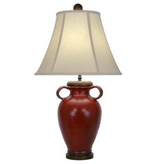 a red vase lamp with a white shade on it