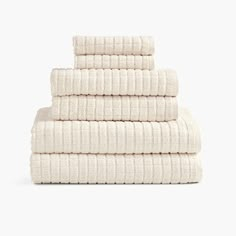 four white towels stacked on top of each other