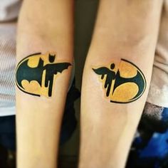 two people with batman tattoos on their legs