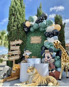 an animal themed birthday party with balloons and jungle animals on the front lawn at disney's animal kingdom