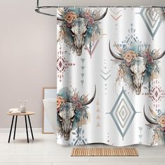 a shower curtain with an animal skull and flowers on it