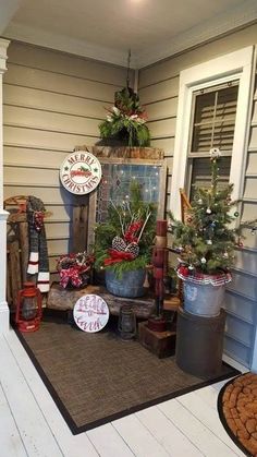 the front porch is decorated for christmas with holiday decorations and other items on display in buckets