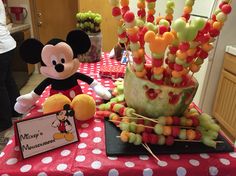 a mickey mouse themed birthday party with candy sticks and marshmallows on the table