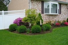 the front yard is neatly trimmed and ready to be used as a flower bed or planter