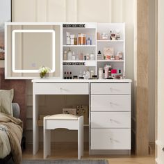 a white vanity with drawers, mirror and stool in front of the dresser is shown