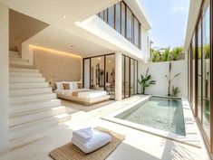 the interior of a modern house with pool and stairs